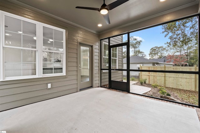 unfurnished sunroom with ceiling fan