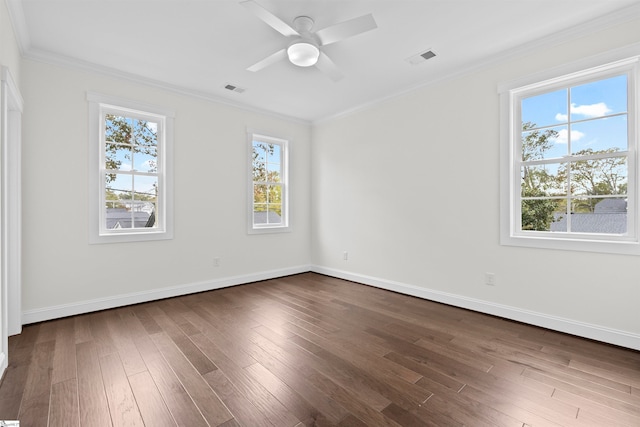 empty room with ceiling fan, dark hardwood / wood-style floors, and ornamental molding