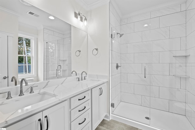 bathroom with vanity, an enclosed shower, and ornamental molding