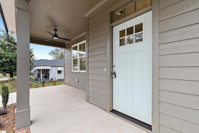 doorway to property with ceiling fan and a porch