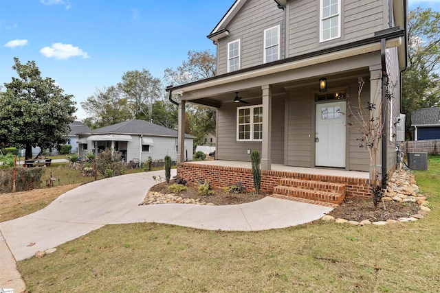 view of front of property with cooling unit, a porch, and a front yard