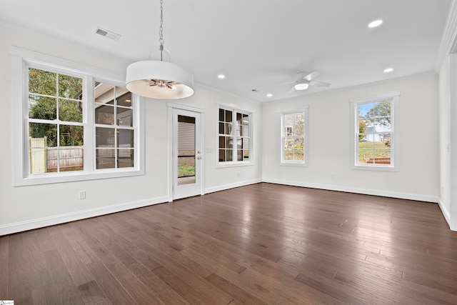 interior space with crown molding, ceiling fan, and dark wood-type flooring