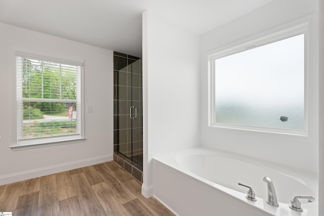 3361 Navin Trl, Roebuck, SC 29376 - bathroom featuring a garden tub, wood finished floors, tiled shower, and baseboards