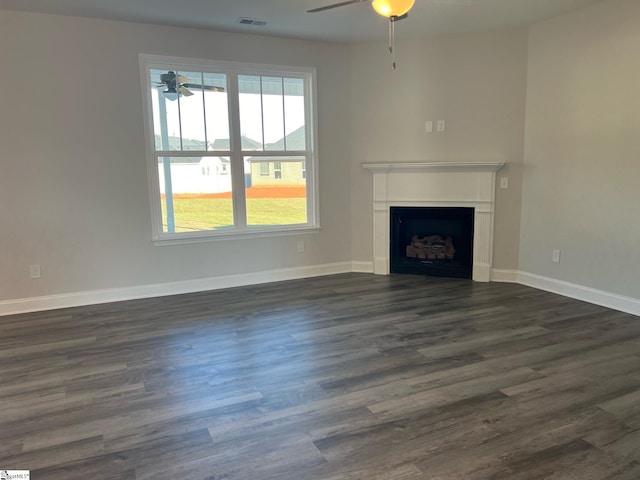 unfurnished living room featuring dark hardwood / wood-style flooring and ceiling fan