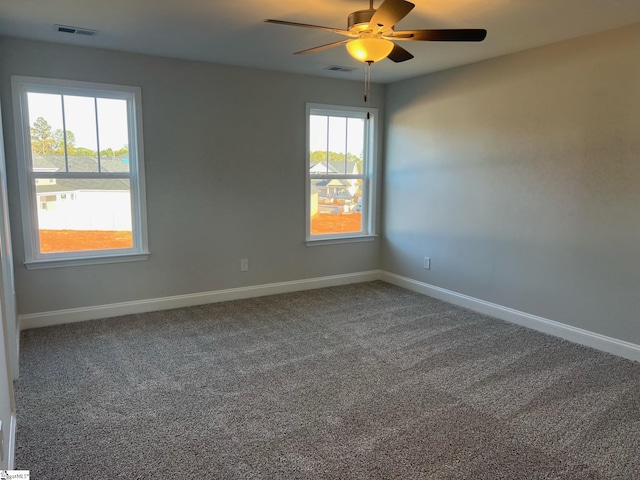 carpeted spare room with plenty of natural light and ceiling fan