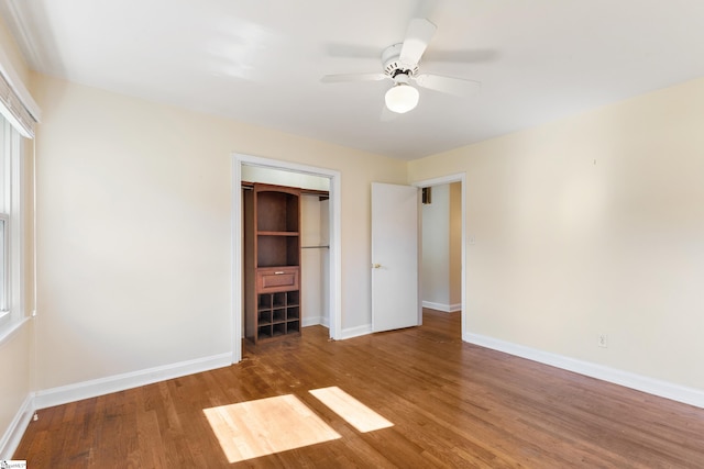 unfurnished bedroom with hardwood / wood-style floors, ceiling fan, and a closet