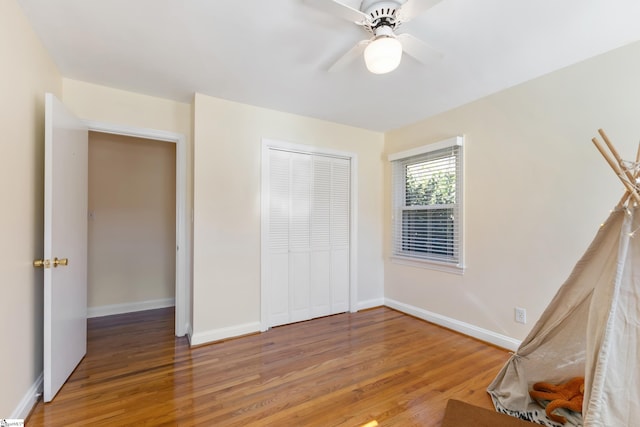 unfurnished bedroom with a closet, ceiling fan, and hardwood / wood-style floors