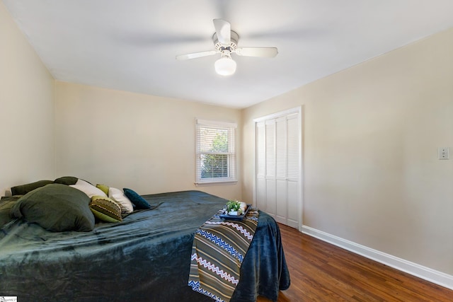 bedroom featuring dark hardwood / wood-style flooring, a closet, and ceiling fan