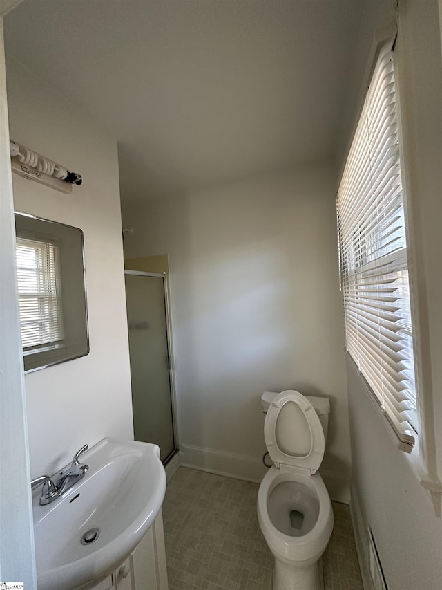 bathroom with toilet, sink, and walk in shower