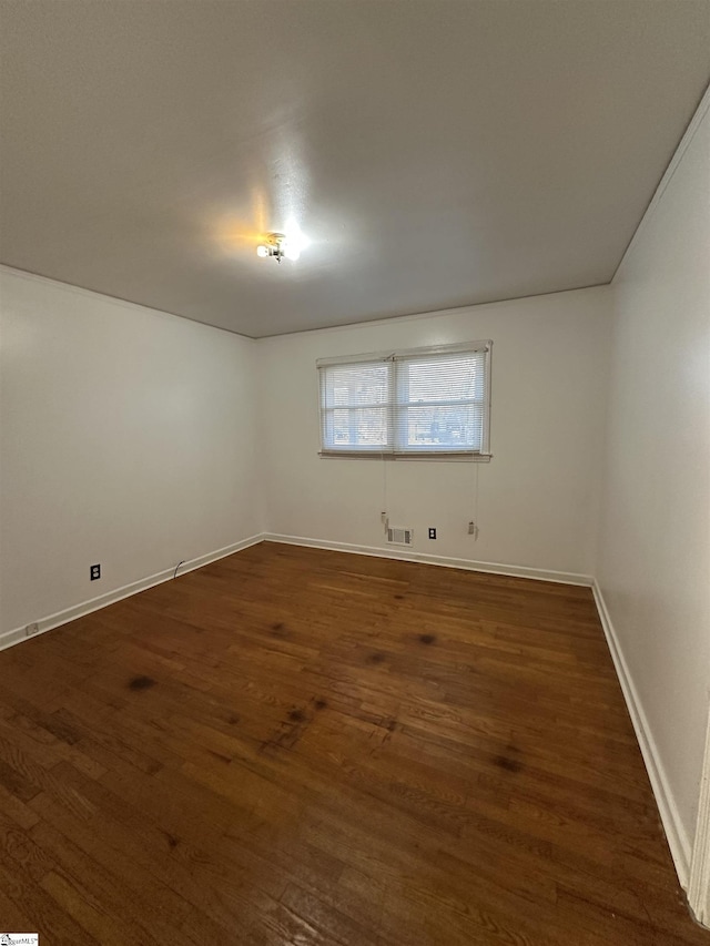 unfurnished room with dark hardwood / wood-style flooring