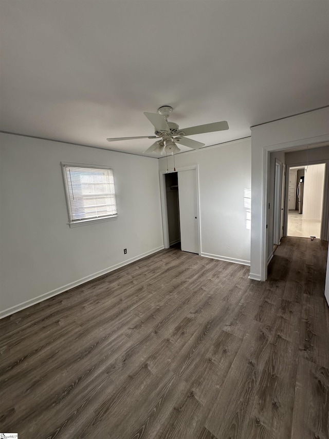 unfurnished bedroom featuring ceiling fan and dark wood-type flooring