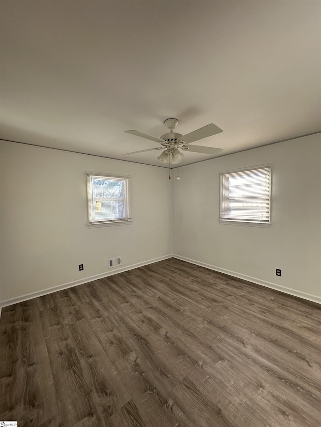 empty room featuring dark hardwood / wood-style flooring and ceiling fan