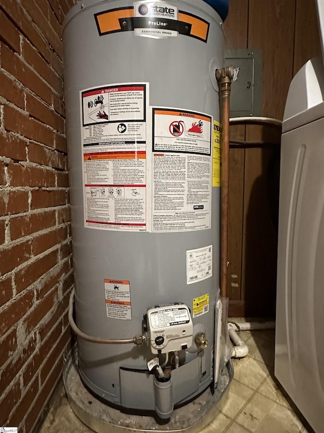 utility room featuring washer / dryer and water heater