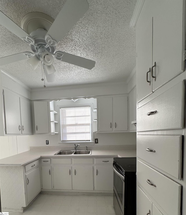 kitchen with ornamental molding, ceiling fan, sink, electric range, and white cabinets