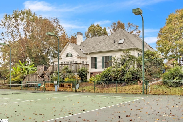 view of tennis court with fence