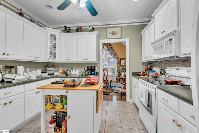 kitchen with white appliances, butcher block counters, light tile patterned floors, and crown molding