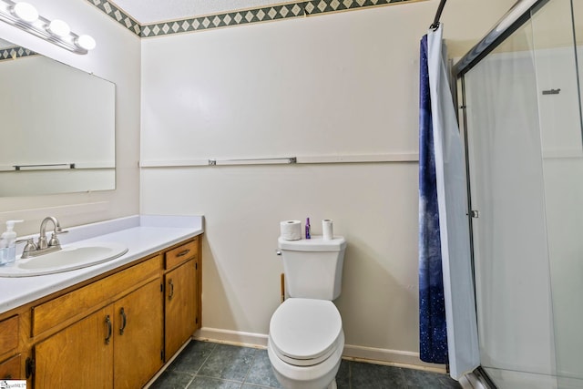 bathroom featuring tile patterned floors, vanity, toilet, and walk in shower