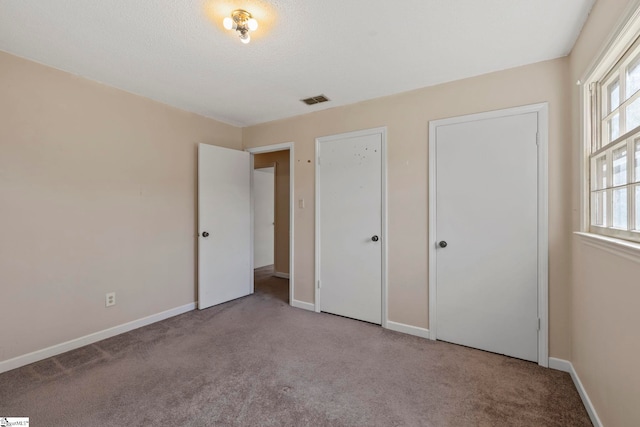 unfurnished bedroom featuring light colored carpet