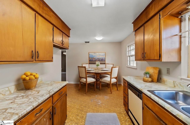 kitchen featuring stainless steel dishwasher, light tile patterned floors, and sink