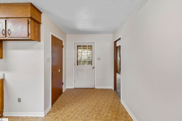 corridor featuring a textured ceiling