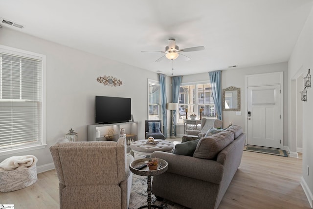 living room with ceiling fan and light hardwood / wood-style flooring