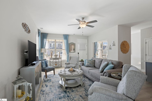 living room with hardwood / wood-style flooring and ceiling fan