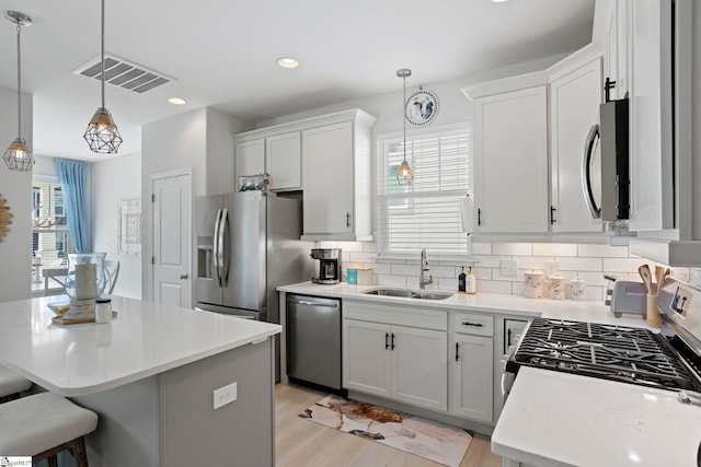 kitchen with white cabinetry, a wealth of natural light, and stainless steel appliances