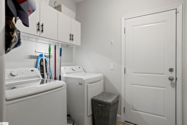 laundry area featuring washer and dryer and cabinets