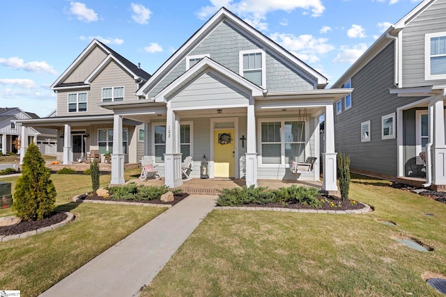 view of front of house featuring a porch and a front lawn