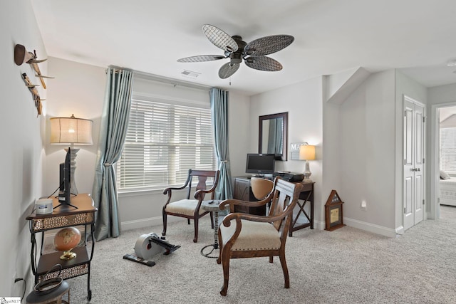 living area featuring ceiling fan and light carpet