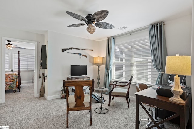 carpeted office featuring ceiling fan