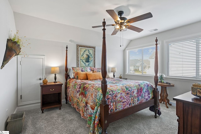 bedroom with light colored carpet, vaulted ceiling, and ceiling fan