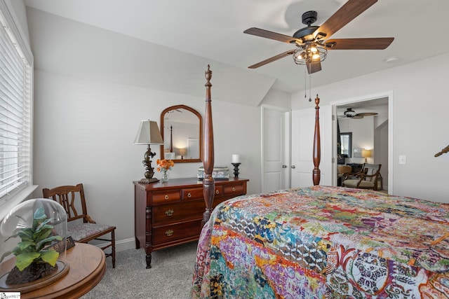 carpeted bedroom with multiple windows and ceiling fan