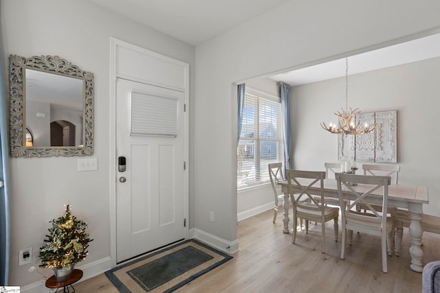 entryway with a chandelier and light wood-type flooring