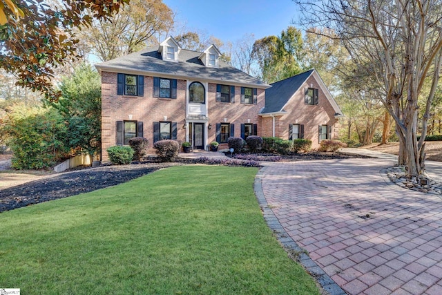 colonial home with a front lawn