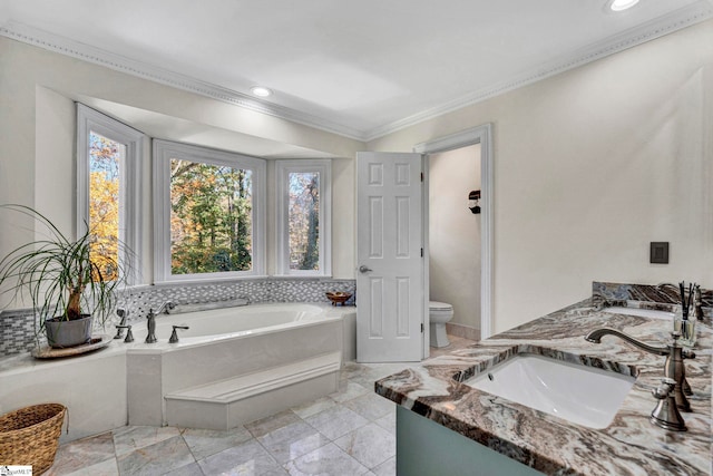 bathroom with crown molding, vanity, a relaxing tiled tub, and toilet