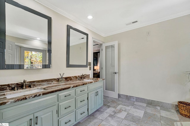 bathroom featuring crown molding and vanity