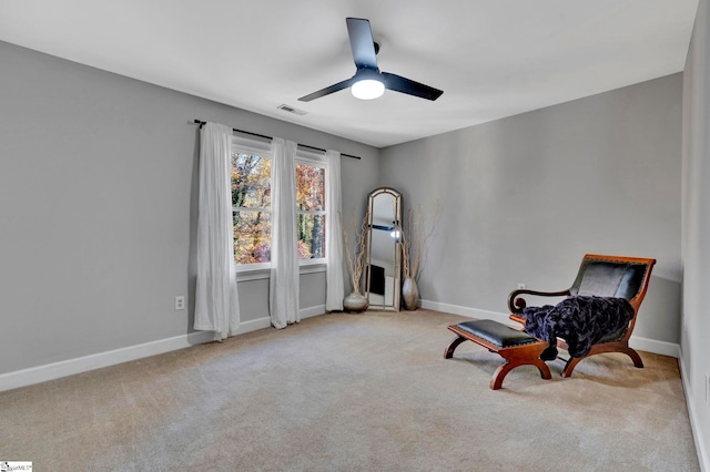 sitting room featuring ceiling fan and light carpet