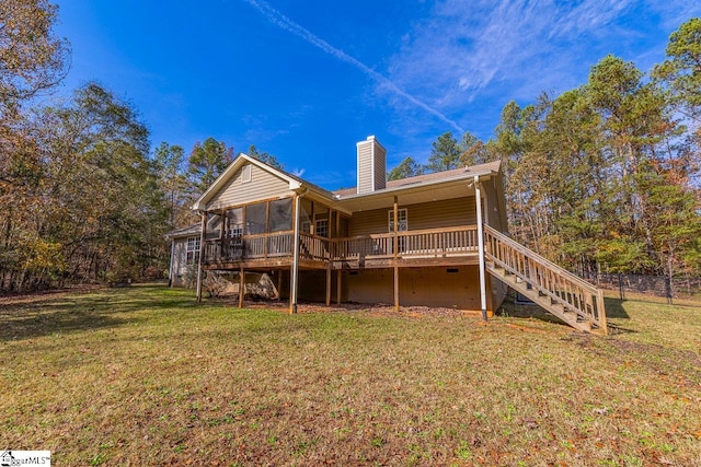 back of house featuring a sunroom, a yard, and a wooden deck