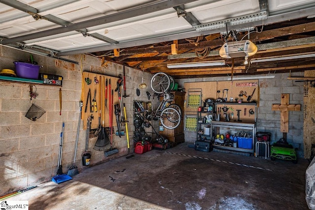 garage with a workshop area and a garage door opener