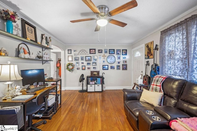 office area with hardwood / wood-style flooring, ceiling fan, and ornamental molding