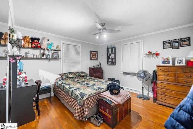 bedroom featuring hardwood / wood-style floors, ceiling fan, crown molding, and a baseboard radiator