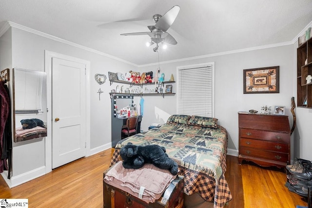 bedroom featuring ceiling fan, ornamental molding, and light hardwood / wood-style flooring