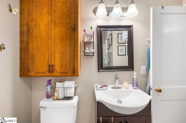 bathroom featuring vanity and toilet