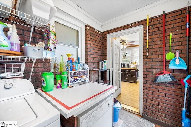 clothes washing area featuring crown molding, ceiling fan, brick wall, and light hardwood / wood-style floors