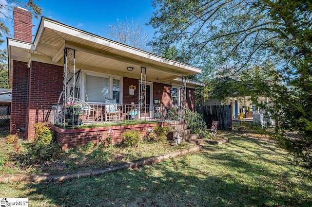 view of front of property with a front yard and a porch