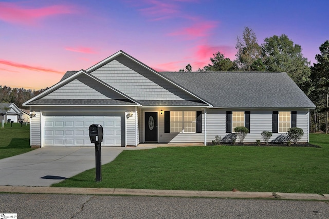 ranch-style home featuring a yard and a garage