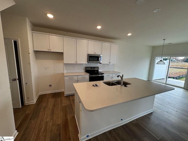 kitchen with white cabinetry, sink, an island with sink, and stainless steel appliances