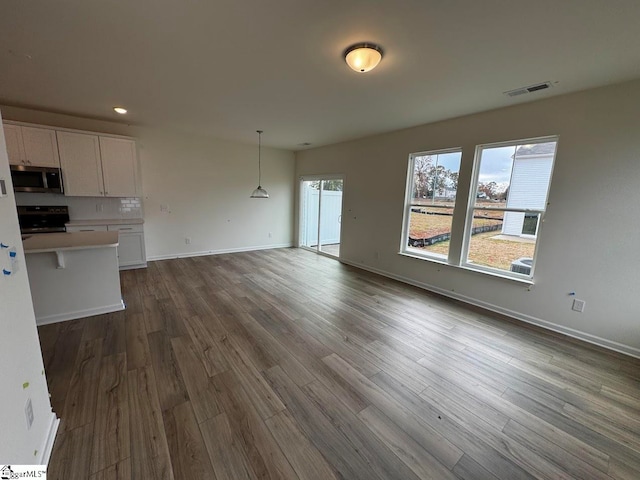 unfurnished living room featuring dark hardwood / wood-style floors