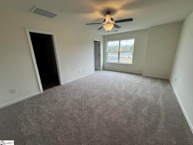 carpeted spare room with ceiling fan